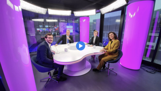 Four people sitting around a table.